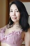 Tsuyako Miyataka spreads her ripe furry Asian pussy after undressing