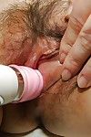 Close ups of Chinese woman Tomoe Nakamachi parting her hairy cum-hole wide