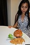 Thai cutie eating burger