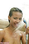 Thai model posing sexily in the washroom whilst cooling off her taut body