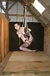 Eastern slavegirl is suspended in rope subordination