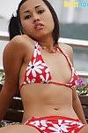 Pretty Thai adolescent in bikini plays peek-a-boo with her arse