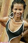Elegant thai brown hair disrobes from her ebon bikini on the sea shore