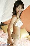 Thai hottie on her daybed posing in and devoid of her appealing underclothes