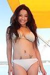 Beautiful bikini princess vera waang stretches on a boat