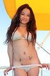 Beautiful bikini princess vera waang stretches on a boat