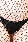 Full-grown Euro woman Corazon Del Bettor posing solo in ripped mesh stockings