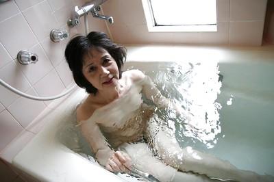 Asian milf Michiyo Fukumoto shows off her tiny tits while in bathroom