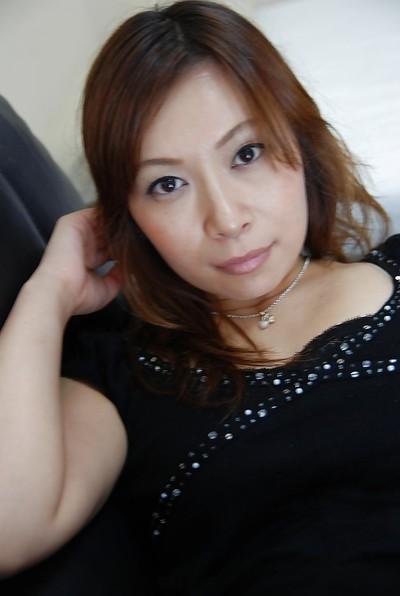 Asian MILF Machiko Nishizaki undressing and exposing her inviting cunt