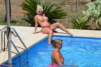Mature amateur Sweet Susi has her cunt pleasured by a gf on the side of a pool