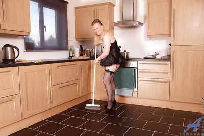 Chubby mature in maids uniform stripping to stockings in the kitchen