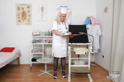 Older blonde nurse Elena stripping off nurses uniform in examination room