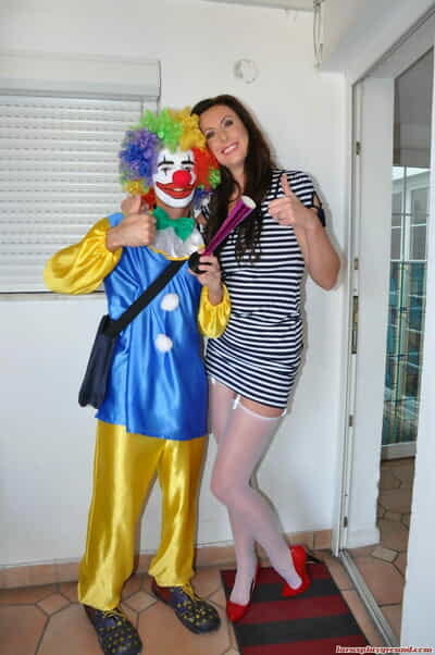 Tall female Lara Latex gets on top of a clowns big cock while having sex