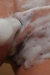 Chubby asian MILF with saggy tits takes shower and teases her hairy slit