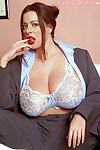 Fat MILF with big tits Linsey Dawn McKenzie posing in a suit.