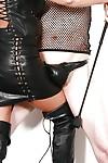 Mature UK femdom pornstar Lady Sarah jerking cock in leather skirt