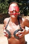 Blindfolded mature woman Lady Sarah playing with exposed nipples outdoors