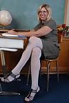 Mature teacher in white stockings and glasses masturbates in classroom