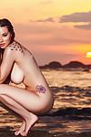 Babe Elizabeth Marxs poses on the beach and plays with big boobs