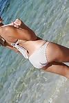 Latina babe Patty drops her bikini bra and flashes tits on the beach