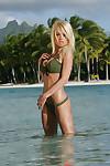 Babe blonde Jesse Jane poses with naked boobies in the ocean