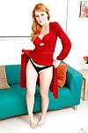 Redheaded MILF Sasha Sean poses fully clothed in bright red dress