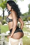Curvy ebony MILF Nyomi Banxxx stripping off her suit and lingerie outdoor