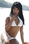 Ebony milf babe Kiki Minaj shows off her big tits in white bikini