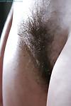 Hirsute amateur Lilou pulls down white panties for hairy cunt viewing