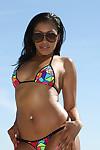 Ebony babe Yasmine De Leon posing in sunglasses and bikini on beach