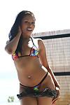 Ebony babe Yasmine De Leon posing in sunglasses and bikini on beach