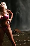 Blonde milf Jesse Jane is posing with naked boobies in front waterfall