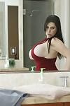 Curvaceous MILF Daphne Rosen slipping on her lacy panties and red dress
