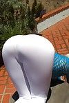 Giant butt fairy model pulls down yoga pants to expose round booty outdoors