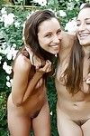 Adorable naked young cuties with charming bodies posing outdoor