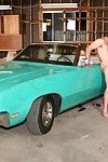 Blonde and a dark hair penetrated on a damp classic car