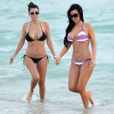 Adolescent celeb kim kardashian posing on the beach