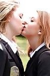 Youthful schoolgirls Cali Sparks and Kelly Greene tongue mouth to mouth outdoors