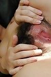 Oriental infant model charming off her underclothing and teasing her wavy gash in close up
