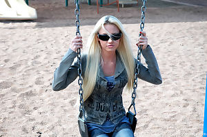 Blond youthful is at the park and this girl looks joyful in her sunglasses