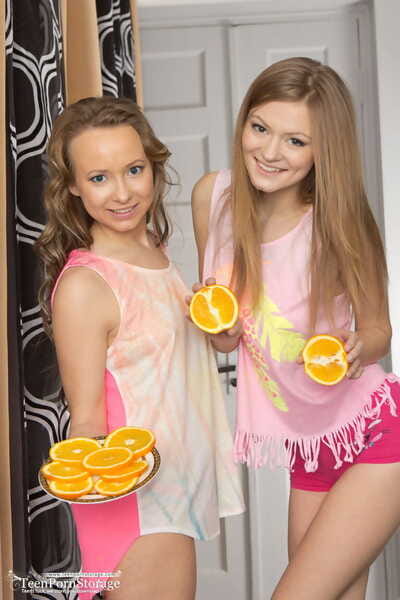 Adolescent looking lesbian hotties Alsu & Patritcy grip orange slices during getting undressed