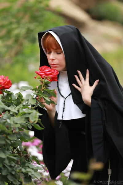 Redheaded nun Penny Pax shows off her major standard bra buddies and and gentile