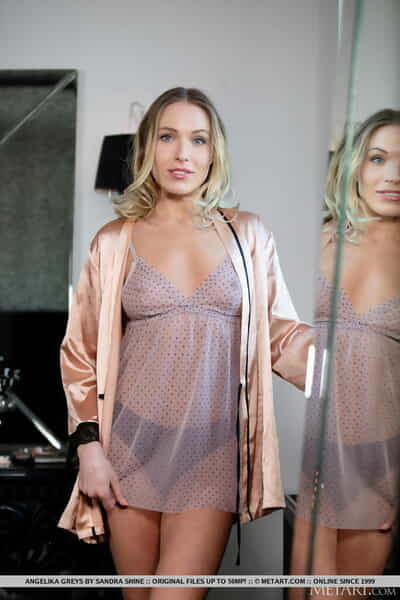 Adolescent golden-haired Angelika Greys removes a robe and her underware to benefits from undressed