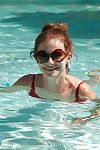 Big tit redhead amateur Essie Halladay having fun nearby a swimming pool