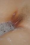 All-natural Asian teen China is stroking her clit in the bathroom