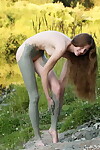 Nude young model with wish legs covers she is in mud from head to toes