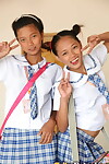 Youthful Japanese schoolgirls lift their uniform skirts to show small nude cage of love