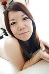Asian teen Shiori Shimizu undressing and exposing her hairy pussy vulnerable the bed