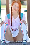 Adolescent redhead in pigtails flashes bawdy cleft at the playground & toys in socks