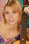 Beautiful youthful toys her inflexible wet crack subsequently strumming her guitar in boots